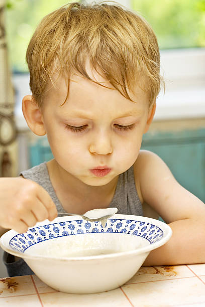 istock Little boy eats hot porridge 94505231