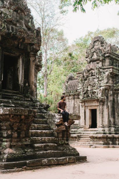 istock Man sitting  in Angkor Temple in Cambodia 945052606