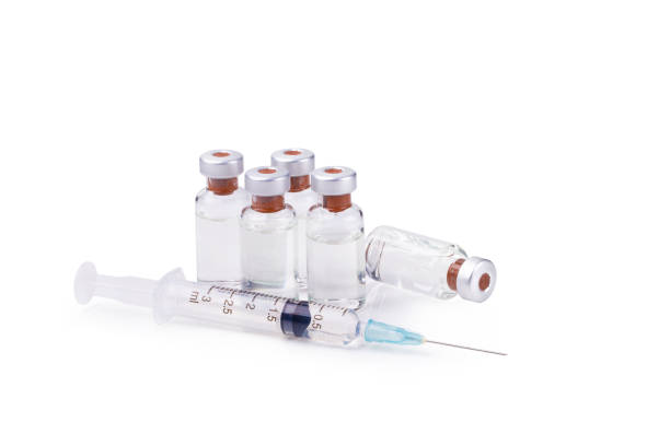 istock Medical vials for injection with a syringe isolated on white background 945053062