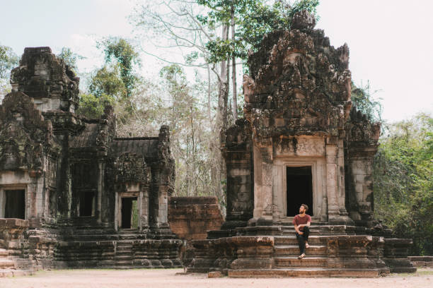 istock Man sitting  in Angkor Temple in Cambodia 945053858