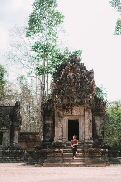 istock Man sitting  in Angkor Temple in Cambodia 945053868