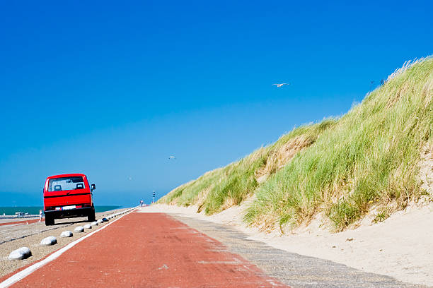 beach road - car beach sedan red 뉴스 사진 이미지