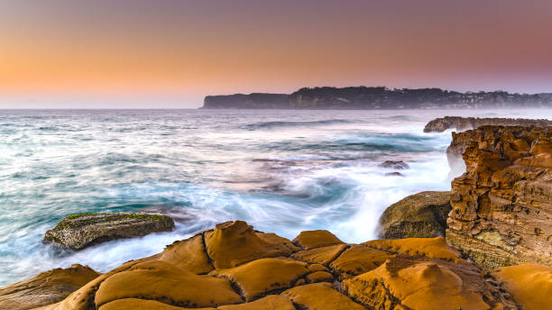 istock Rocky Sunrise Seascape 945057904