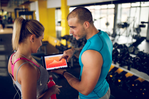 istock Trainer explaining workout regime to woman 945061968