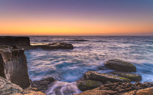 istock Rocky Sunrise Seascape 945062080