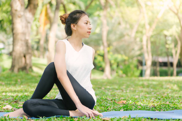 istock Young asian woman yoga outdoors keep calm and meditates while practicing yoga to explore the inner peace. Yoga and meditation have good benefits for health. Yoga Sport and Healthy lifestyle concept. 945062824
