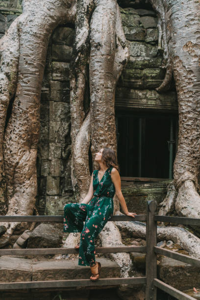 istock Young Caucasian woman   in Ta Prohm temple 945063110