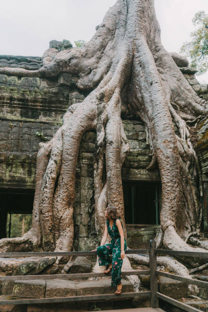 istock Young Caucasian woman   in Ta Prohm temple 945063114
