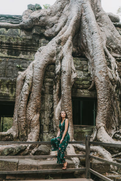 istock Young Caucasian woman   in Ta Prohm temple 945065754