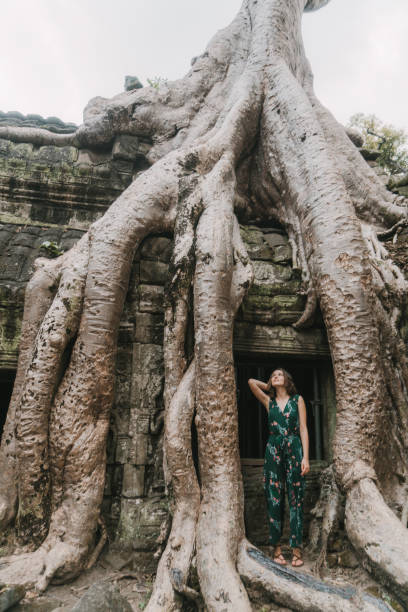 istock Young Caucasian woman   in Ta Prohm temple 945066170