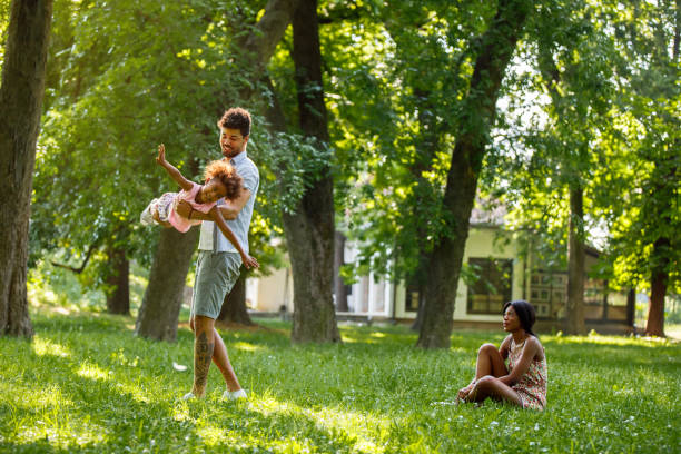istock Father carrying his daughter and helping her fly 945066448