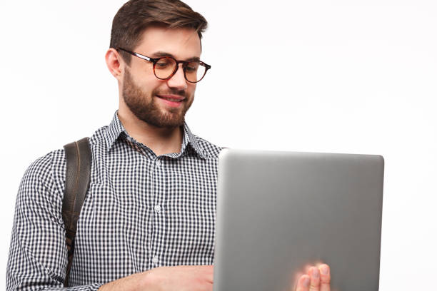 istock Casual guy with laptop on white 945069212