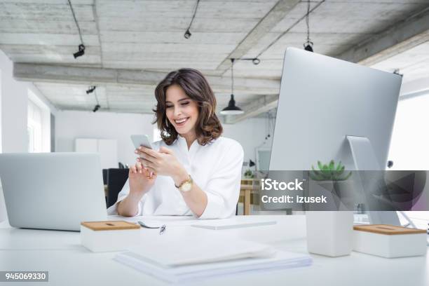Smiling Businesswoman Making A Phone Call In Office Stock Photo - Download Image Now