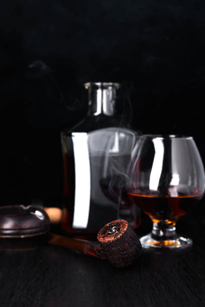 istock Glass of whiskey with smoking cigar. 945070310