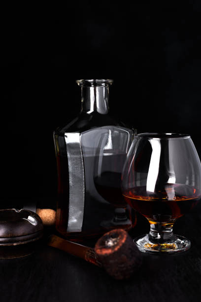 istock Glass of whiskey with smoking cigar. 945070344