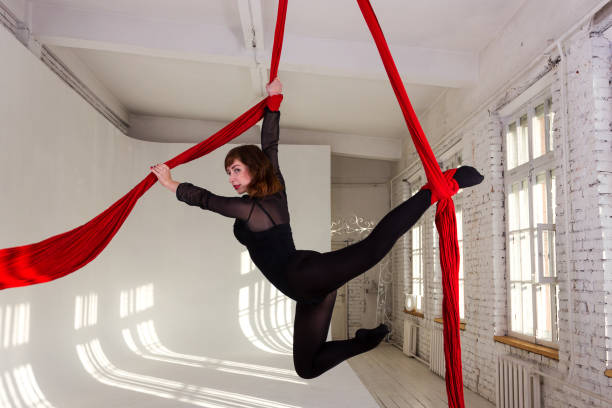 istock Girl training on aerial silks 945073136