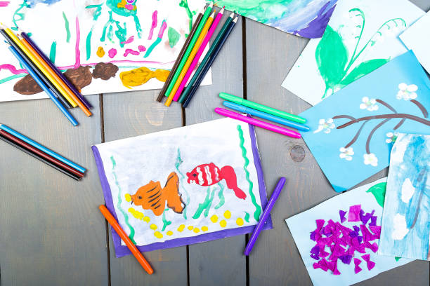 istock Child pictures. Top view.  Kid drawings. Flat lay. 945073814