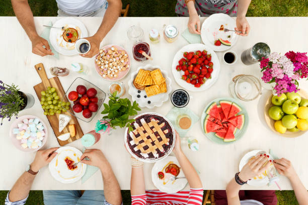 istock Woman sharing cake with friends 945078074