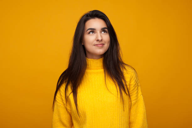 istock Dreaming content girl on yellow 945078718