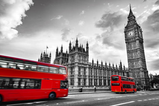 London, the UK. Red buses in motion and Big Ben London, the UK. Red buses in motion and Big Ben, the Palace of Westminster. The icons of England in vintage, retro style. Red in black and white clock tower photos stock pictures, royalty-free photos & images