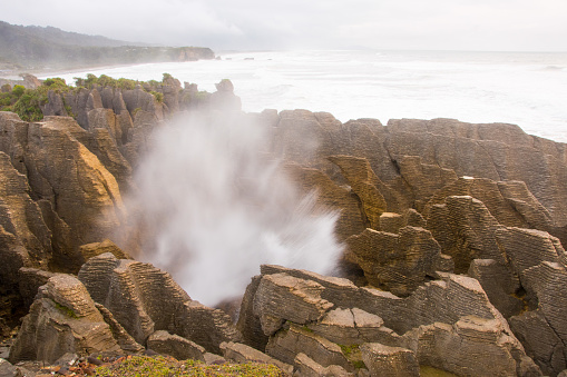 Along the cost of Punakaiki, South Island of New Zealand there are limestone formations known as the Pancake Rocks. A blowhole creates spectacular views. October 2017