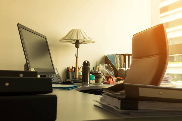 istock Work desk in office by the window with sun flare 945082344