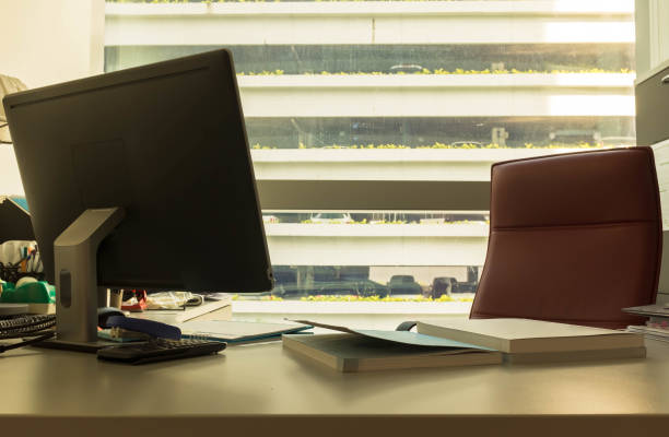 istock Work desk in office by the window with sun flare 945082346