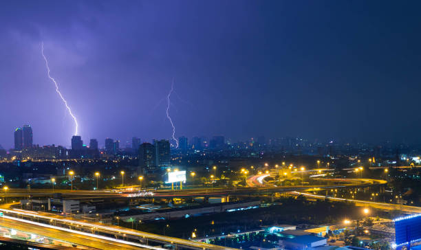 istock electric lightning strikes in city with high way road 945082406