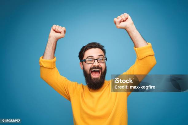 Excited Man In Yellow Holding Hands Up Stock Photo - Download Image Now - People, Men, Happiness
