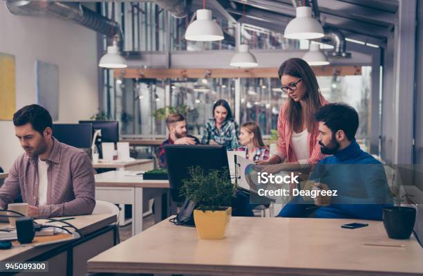 Young Woman Showing Diagrama Of Growth To Her Colleague Stock Photo - Download Image Now