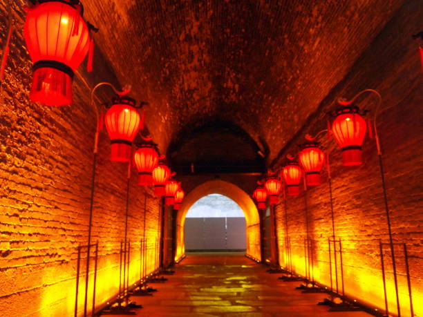 Tunnel in the thick wall lit with red chinese lanterns