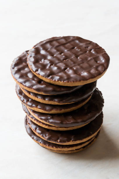 istock Stack of Chocolate Covered Round Jaffa Cookies / Whole Wheat. 945094040