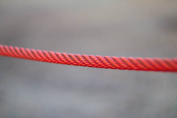 istock red rope in front of gray background 945094350