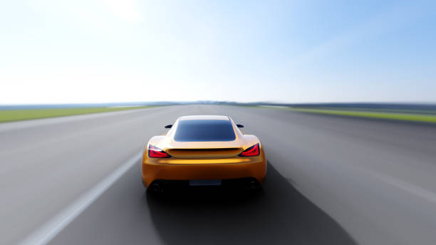 istock orange car driving on a road 945094848