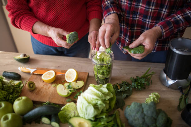 istock Senior couple preparing ingredients for green smoothie 945097036