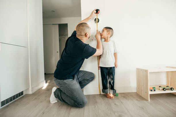istock Recording the Height of a Boy 945097346