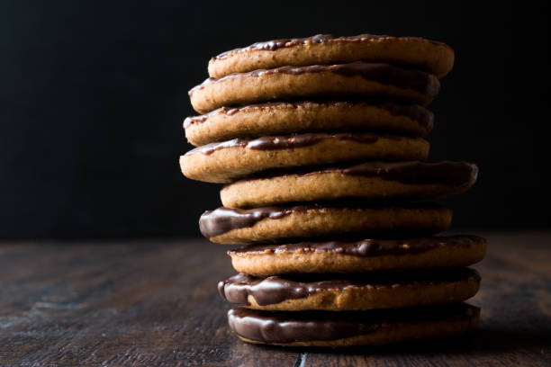 istock Stack of Chocolate Covered Round Jaffa Cookies / Whole Wheat. 945097390