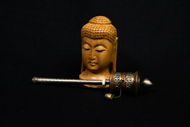 Studio shot of small Buddha and Prayer Wheel