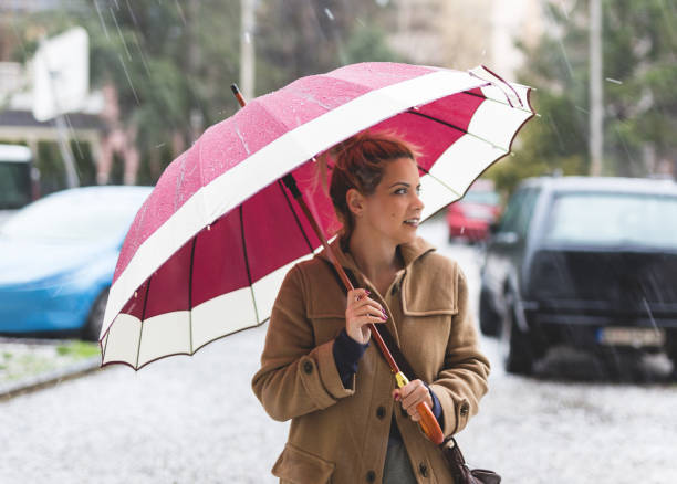 istock Lady walking on the strong rain 945098142