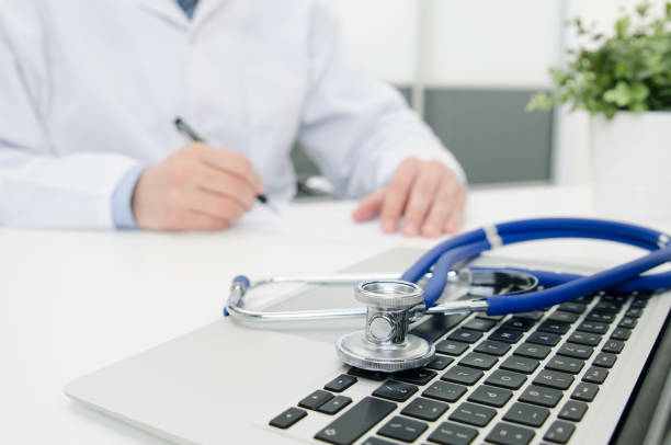istock Doctor working in hospital. Stethoscope on laptop keyboard 945098324
