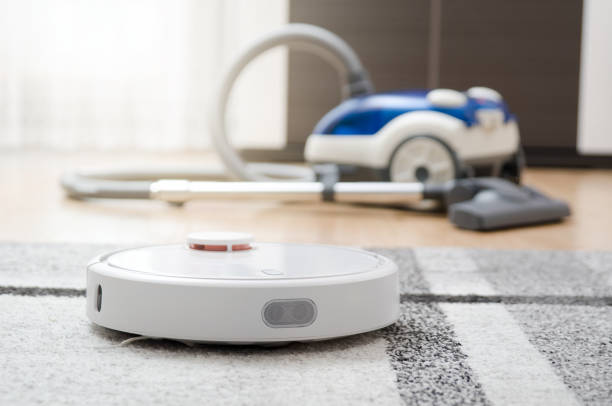 istock Robotic vacuum cleaner cleaning the room 945098366