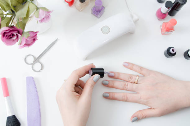 istock Woman using UV light dryer. Manicure, spa salon concept 945099996