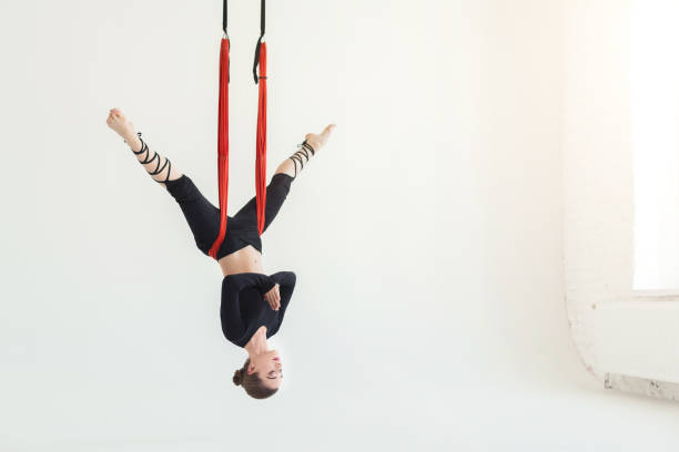 istock Woman practicing fly yoga over white background 945100824