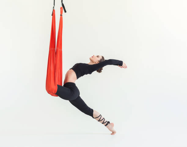 istock Woman practicing fly yoga over white background 945100838