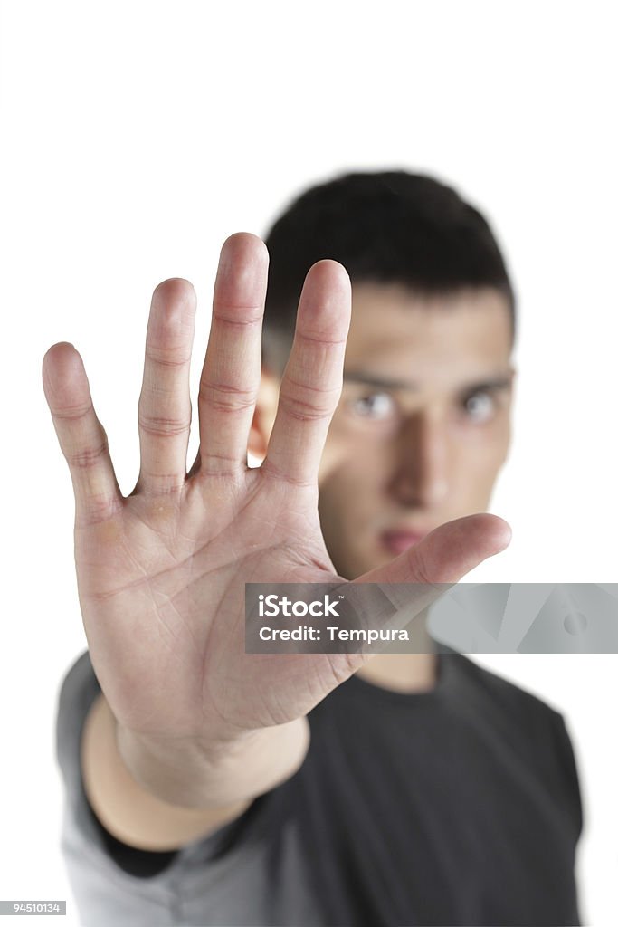 Joven haciendo la señal de pare (stop) con la mano - Foto de stock de Blanco - Color libre de derechos