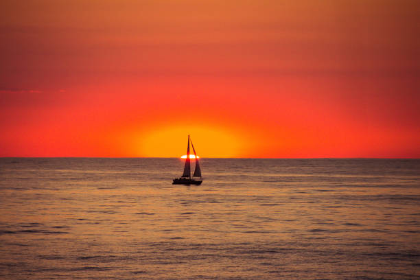 istock Sunset on the sea with a boat 945105006
