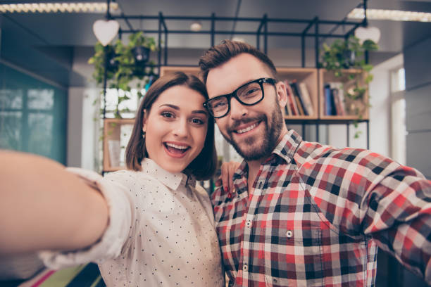 istock Two happy laughing colleagues making selfie during break 945105132