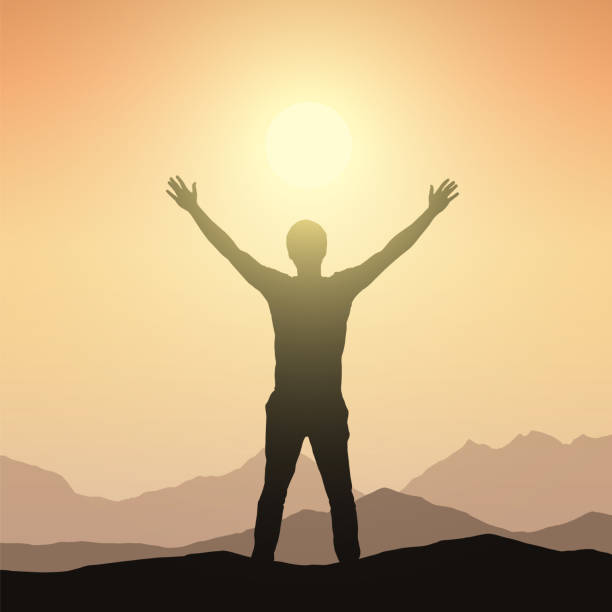 istock Realistic silhouette of a man welcoming sunrise in a mountain landscape with orange sky - vector 945105520