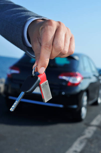 man offering a car key to the observer