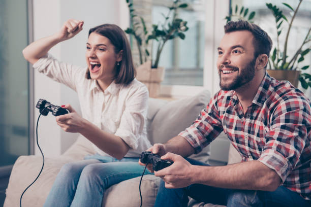 istock Two excited happy lovers playing video game 945106642